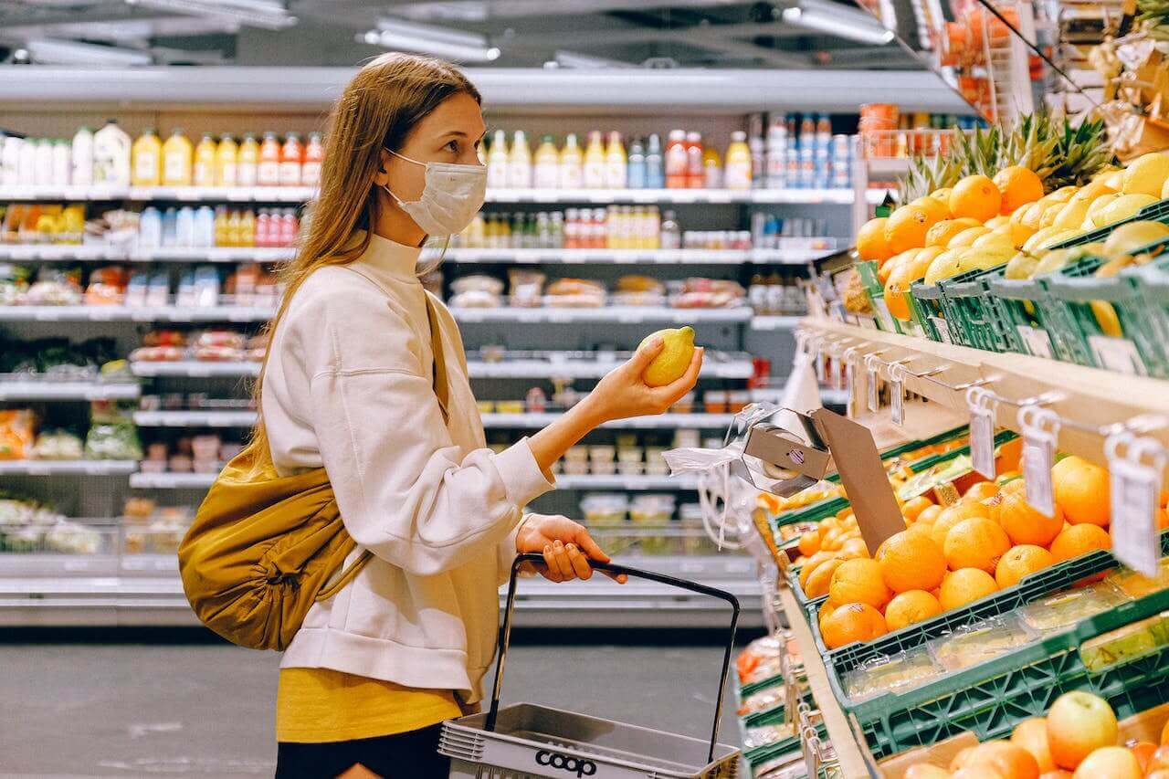Lady at supermarket in the fruit section